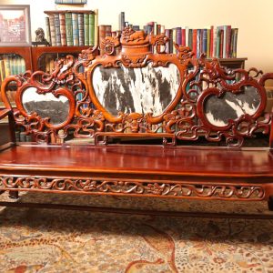 25.  Chinese rosewood sofa. Hand carved in dragon motif and with marble inserts. Mid 20th century. 