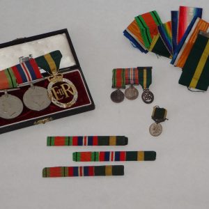14.  Collection of military medals and stripes. Three WWII British War Medals and their miniatures, ribbon bars and extra ribbon, an additional WWII miniature medal, 