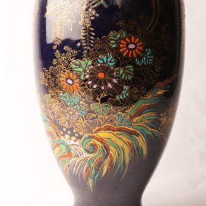 52. Porcelain flower vase.  Blue ground and hand painted floral decorations.  Probably English. Carlton Ware style.  Early 20th century.  