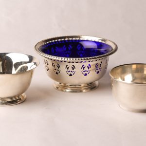 58. Three Birks' sterling silver bowls.  One with blue glass insert and two small nut bowls.  Three pieces.  
