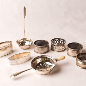 87. Sterling silver collection. Six napkin rings and two strainers. Eight pieces.  