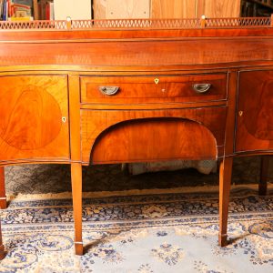 19. Solid mahogany buffet. Heppelwhite design with curved front, ivory escutcheons, and tapering legs.  Mid 19th century.  
