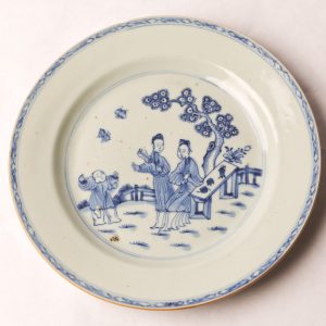21. Chinese export porcelain plate.  White ground and blue ink depicting women and boy chasing butterflies.  Ching Dynasty (Chien Lung Period 1739-1795).  See accompanying paperwork.  
