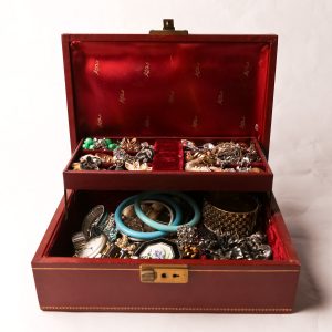 65. Costume jewelry collection. With jewelry box. Includes sterling, rhinestones, and miscellaneous vintage pieces.  