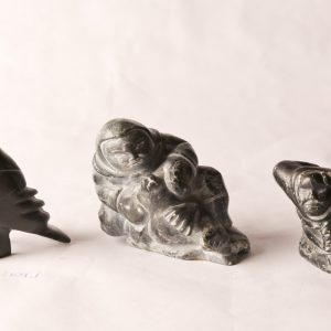 102. Three Inuit soapstone carvings. Mathewsie Amidlak woman and seal; Peter Etiodloie hunter; Martha Ekutisluk bird.