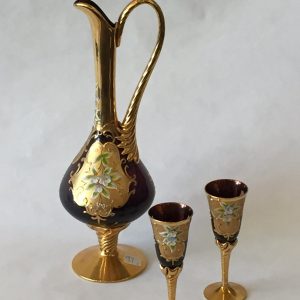 97. Murano glass claret set.  Hand blown purple glass ewer with gold and foliate painted motif.  With six